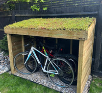 Bike store / bike shelter with sedum green roof. Wooden bicycle storage, made in the UK. Outdoor bike storage