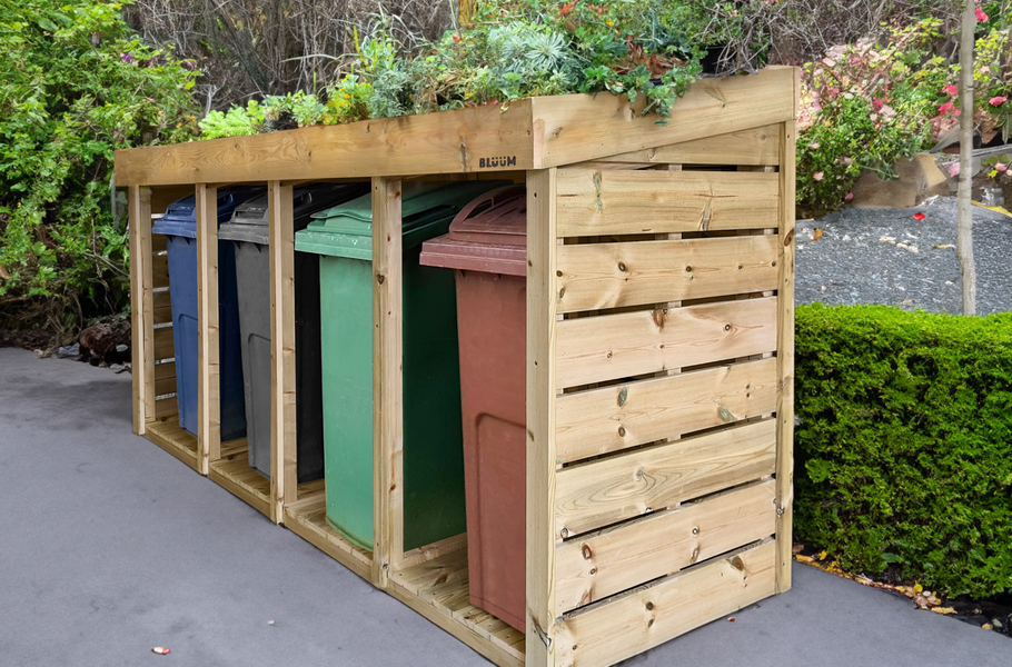 Wooden four wheelie bin store with green roof