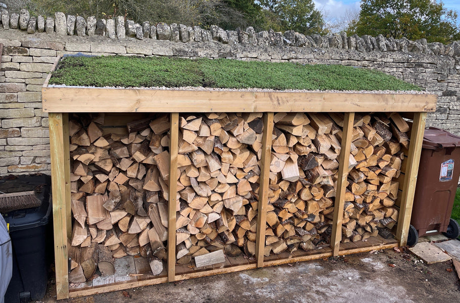 Log store with a living green roof planter, filled with sedum plants. Perfect to store your firewood outside