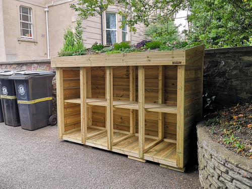 Large recycling storage unit for eight recycling boxes, keeping them tidy. Plants are added to the roof planting area. 