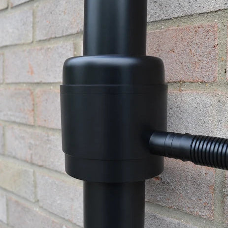 Ecosure filtered rainwater diverter kit fitted to a black downpipe, feeding a garden water butt