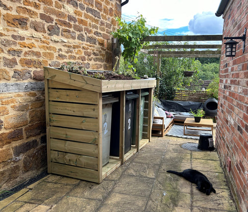 Triple wheelie bin store with a living green roof planter 
