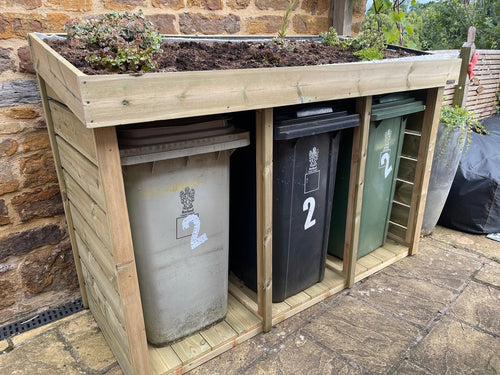 Triple wheelie bin store with a living green roof planter 