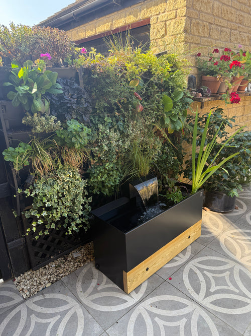A 100cm Dipping Tank with 30cm Waterfall accessory, sitting in front of he PlantBox Living Wall System (all products available through our website). Made in the UK, sustainable water storage. Aluminium water tanks
