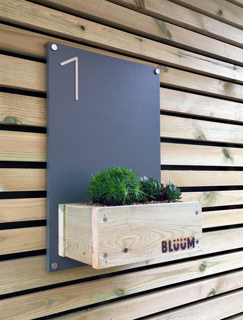Grey painted house plaque number sign with stainless steel numbers and planting area