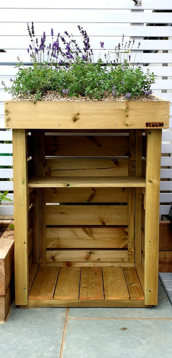 Mini log store, shown with kindling shelf. Wood storage box with green roof planter. UK made firewood storage. Outdoor log storage with living roof top. 