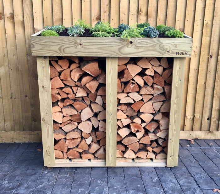Wooden firewood log storage from Bluum Stores, with a living green roof planter top. Outdoor UK log storage. Firewood storage with a green roof. Handmade log storage 